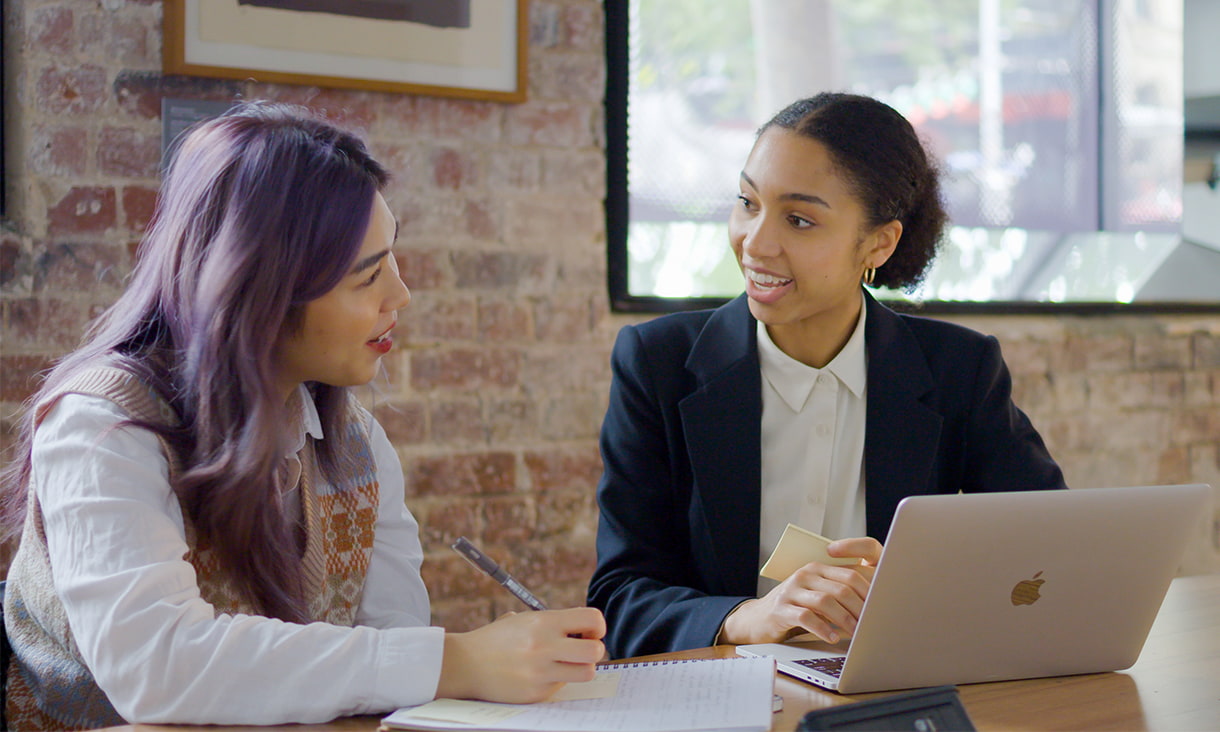 international students sitting in front of table and talking