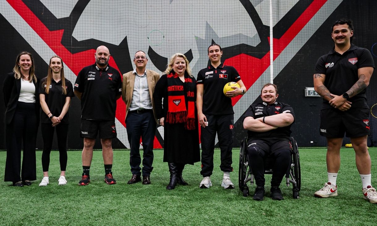 Deputy Vice-Chancellor Mish Eastman (centre) with AFLW Co-Captain Bonnie Toogood, VWFL coaches/players Chris Henderson and Gary Overliese, Essendon Football Club CEO Craig Vozzo, Essendon Education Academy Manager Kirsten Hannah and Essendon Education Academy students Jade Hallett and Anton Amalfi