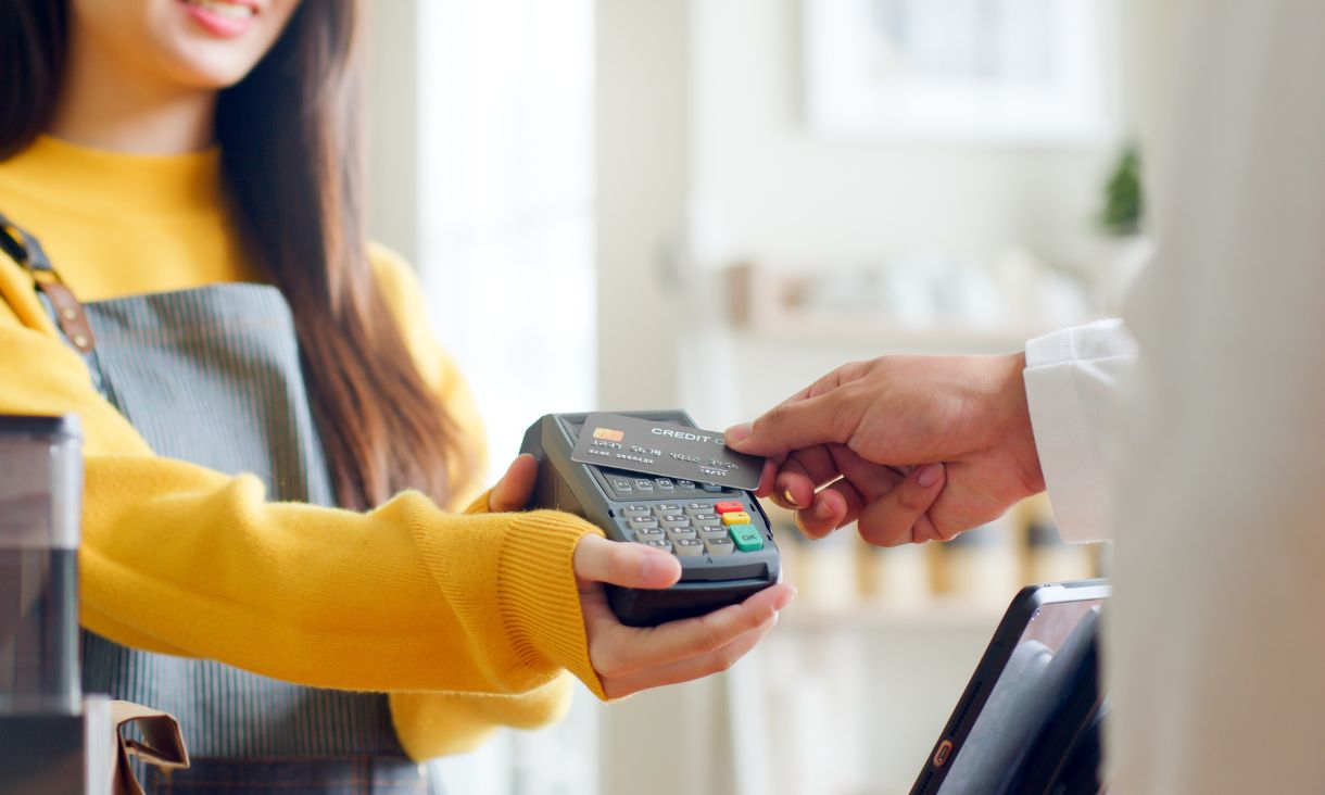 Person tapping a card on an efpos machine