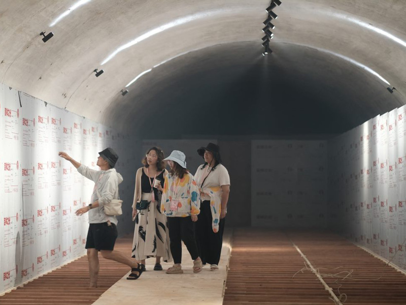 People inside unwrapping a hall of mirrors