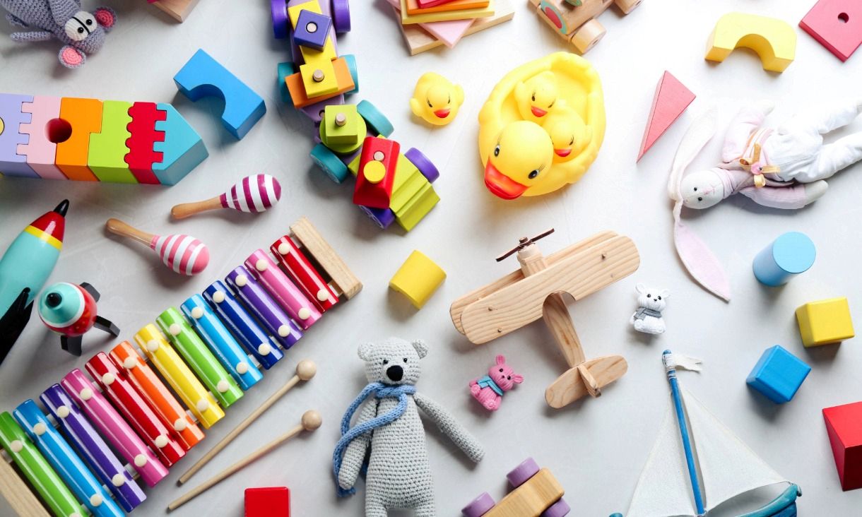 Different toys on light background, flat lay