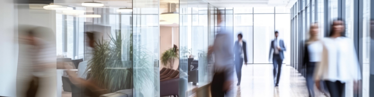 People walking down a hall in a corporate office.