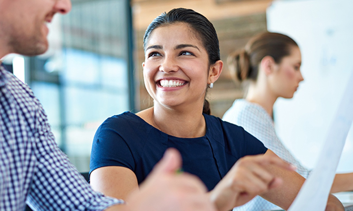 A woman smiles at her coworker.