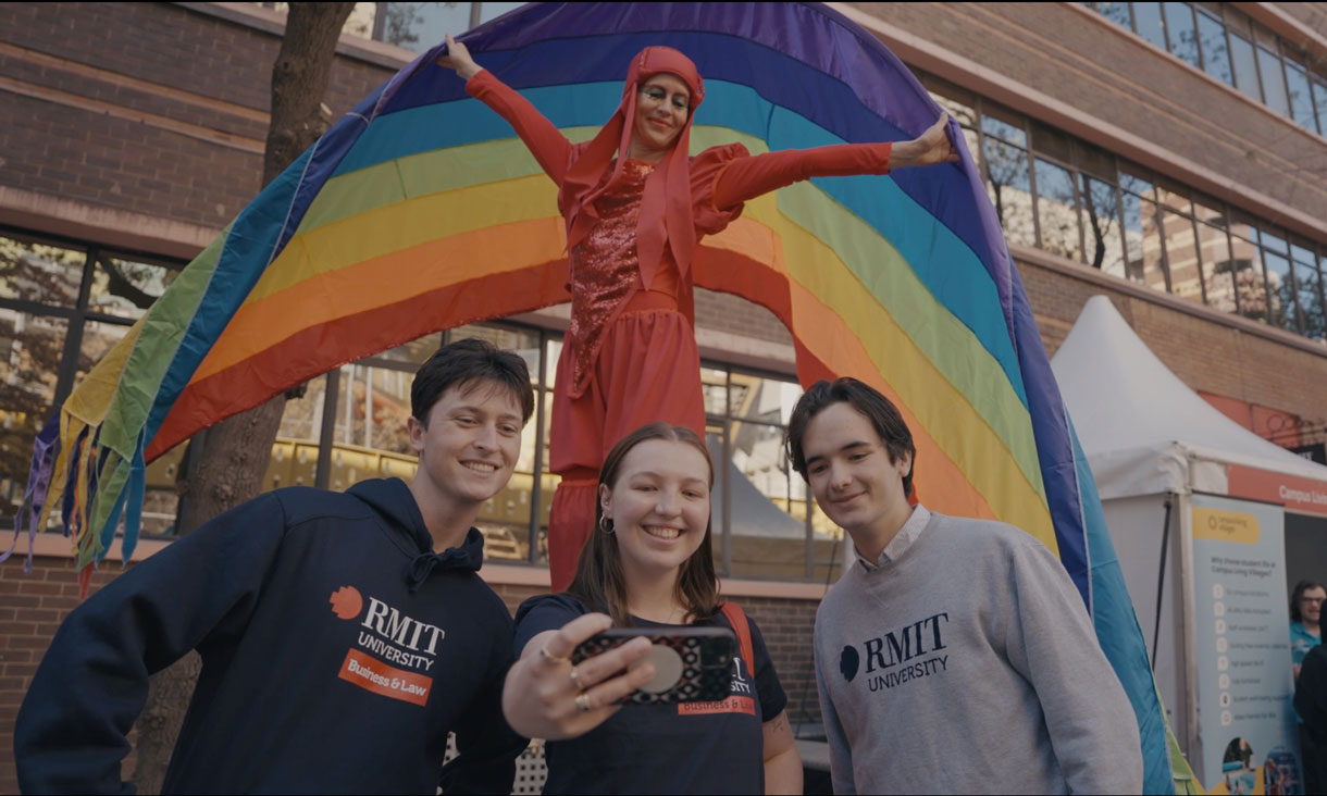 Three students taking a photo at RMIT open day 