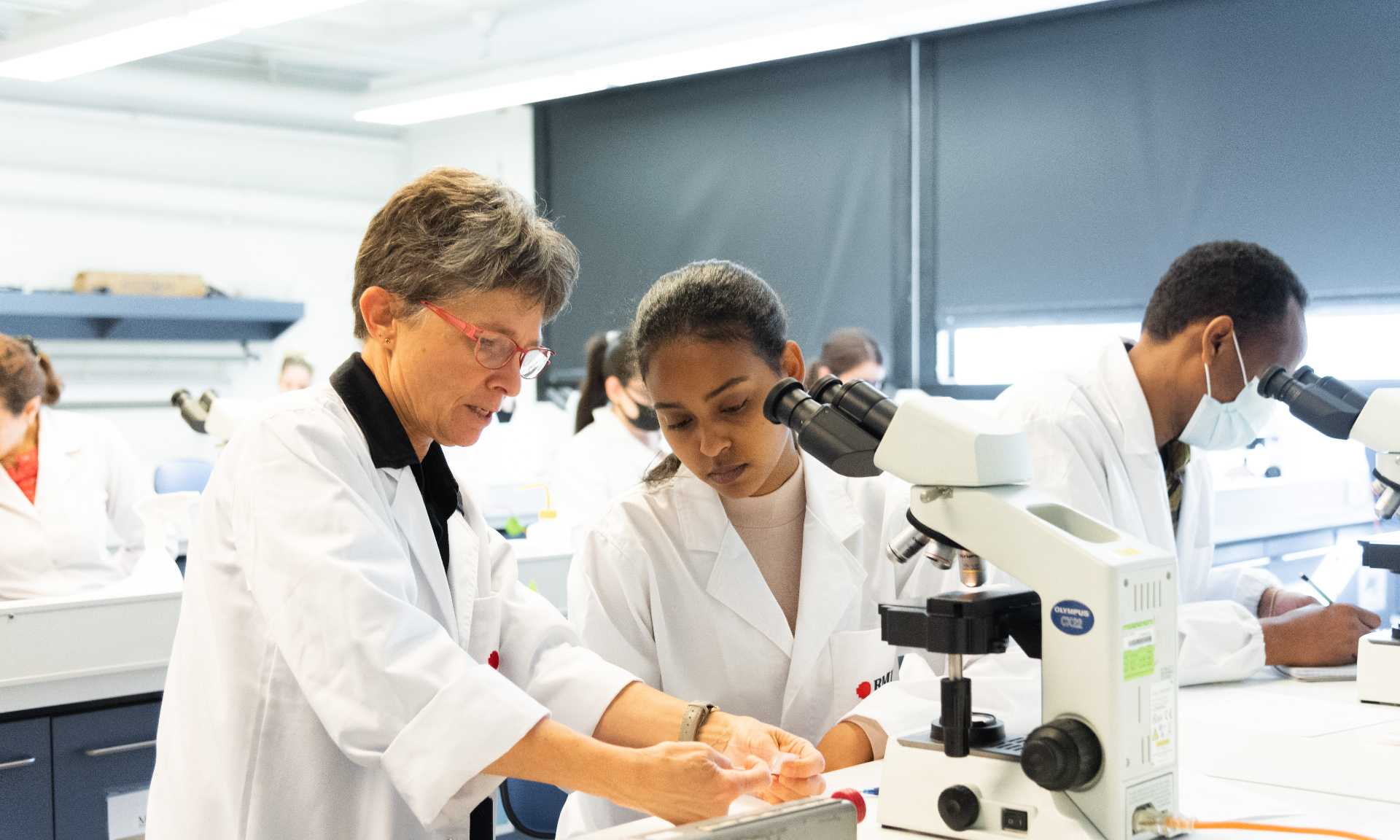People working in science lab with microscope