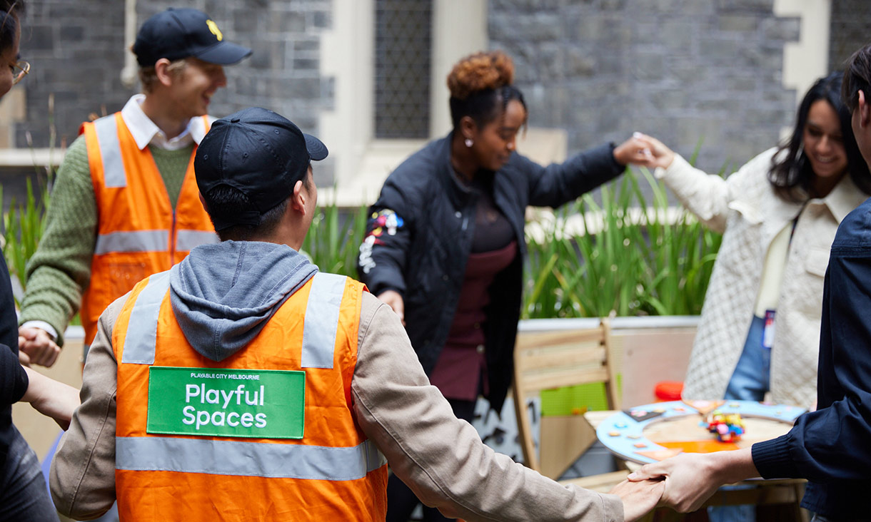group of people holding hands outdoors