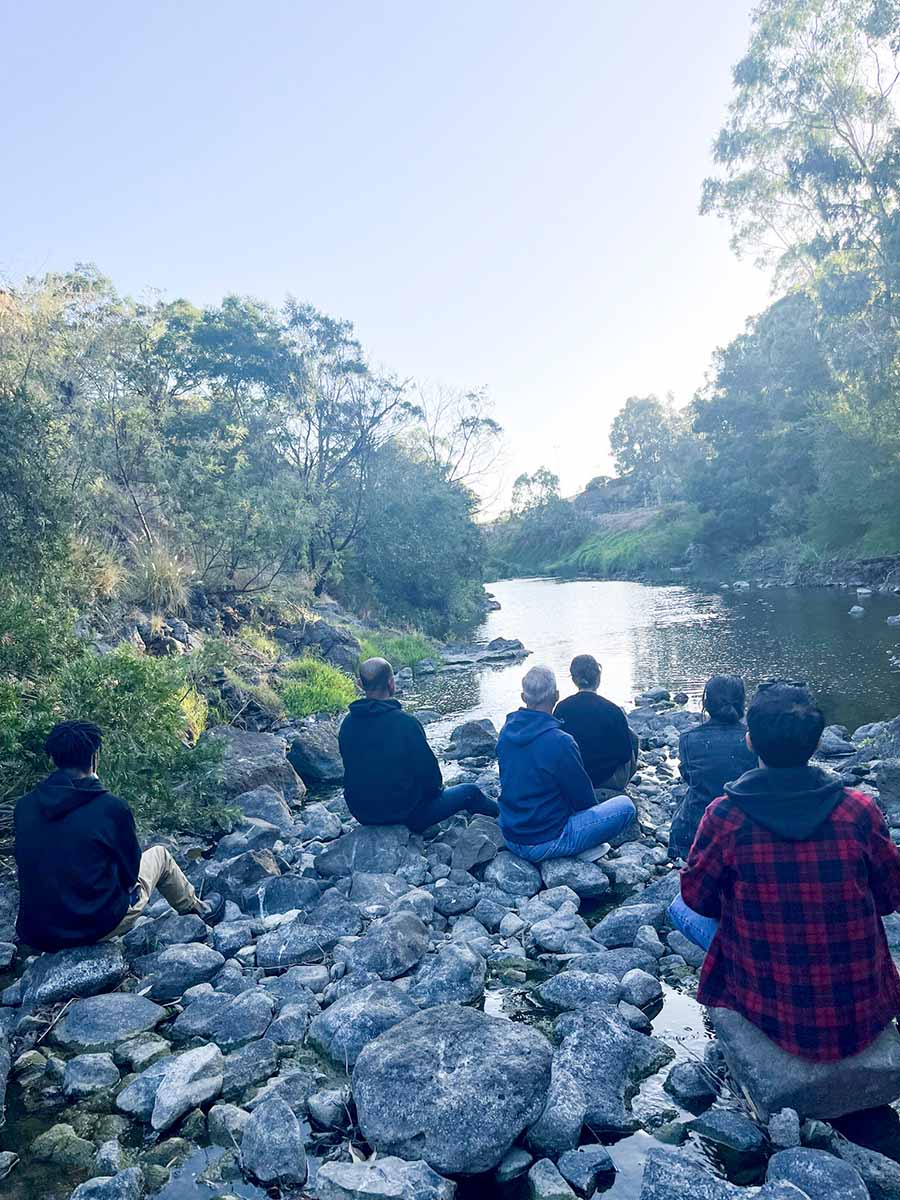 People sitting by the river.
