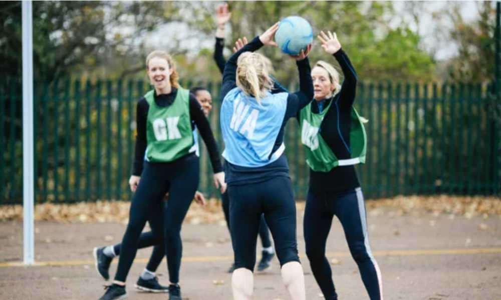 People playing netball on court outside