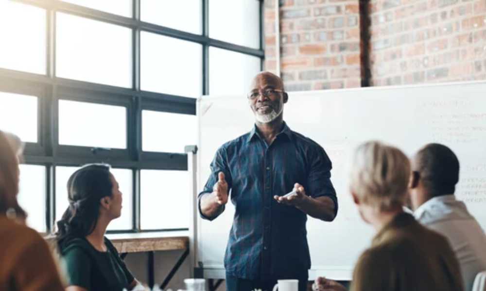 Person in front of whiteboard training a group