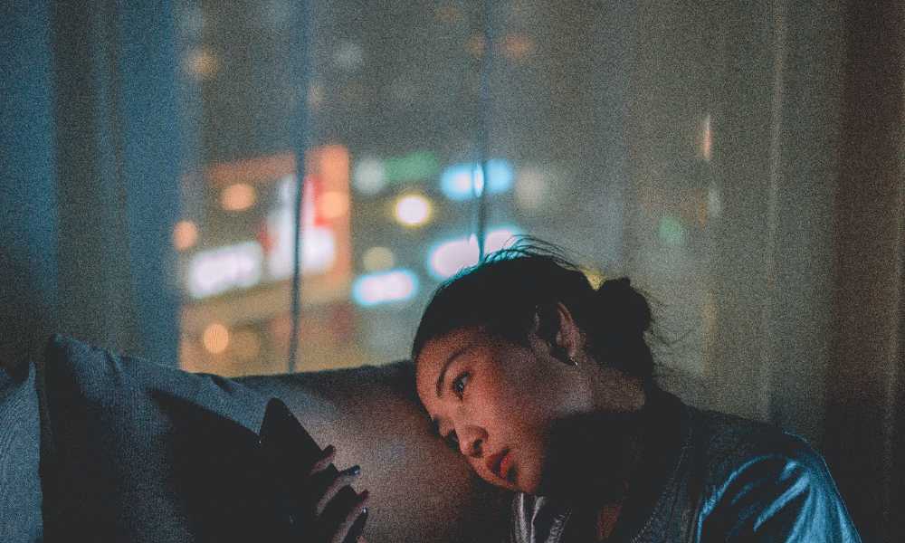 Person sitting on couch looking at their phone