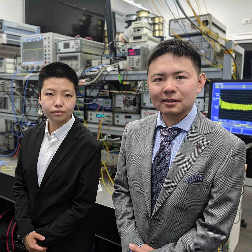 Two people standing in a computer room