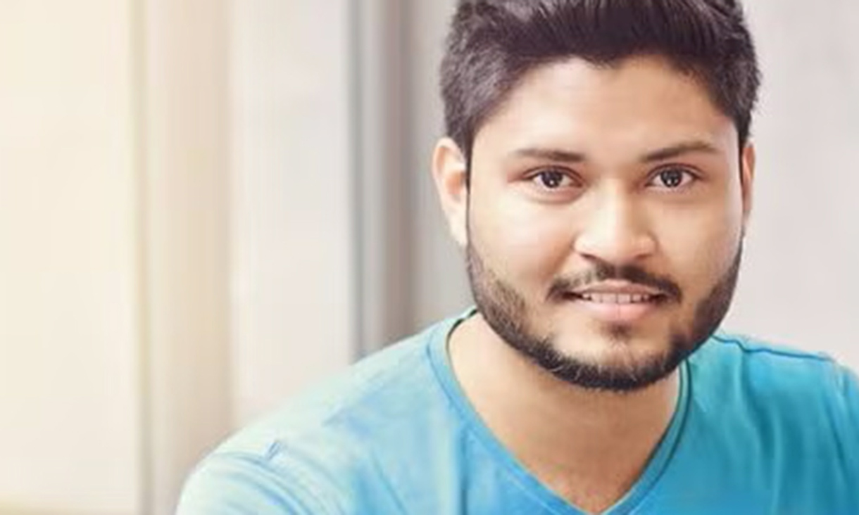 A male professional staring into the camera lens with a look of slight concern.