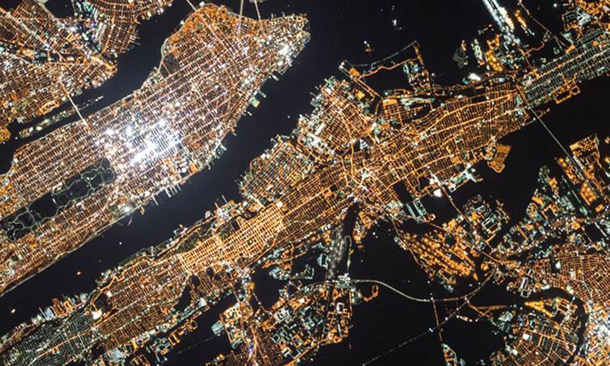 Birds eye view of a lit up city area at night time.