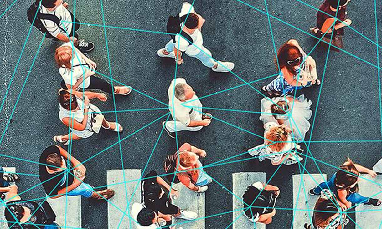 People walking across a busy zebra crossing. Blue graphic lines link them to one another. 