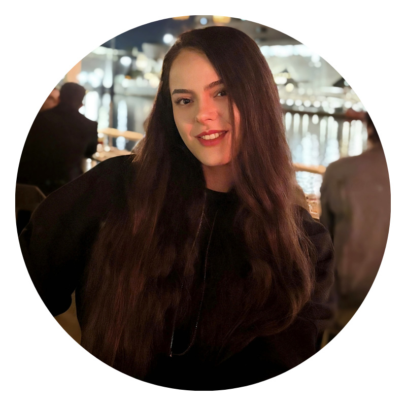 Female student with long brown hair smiling.