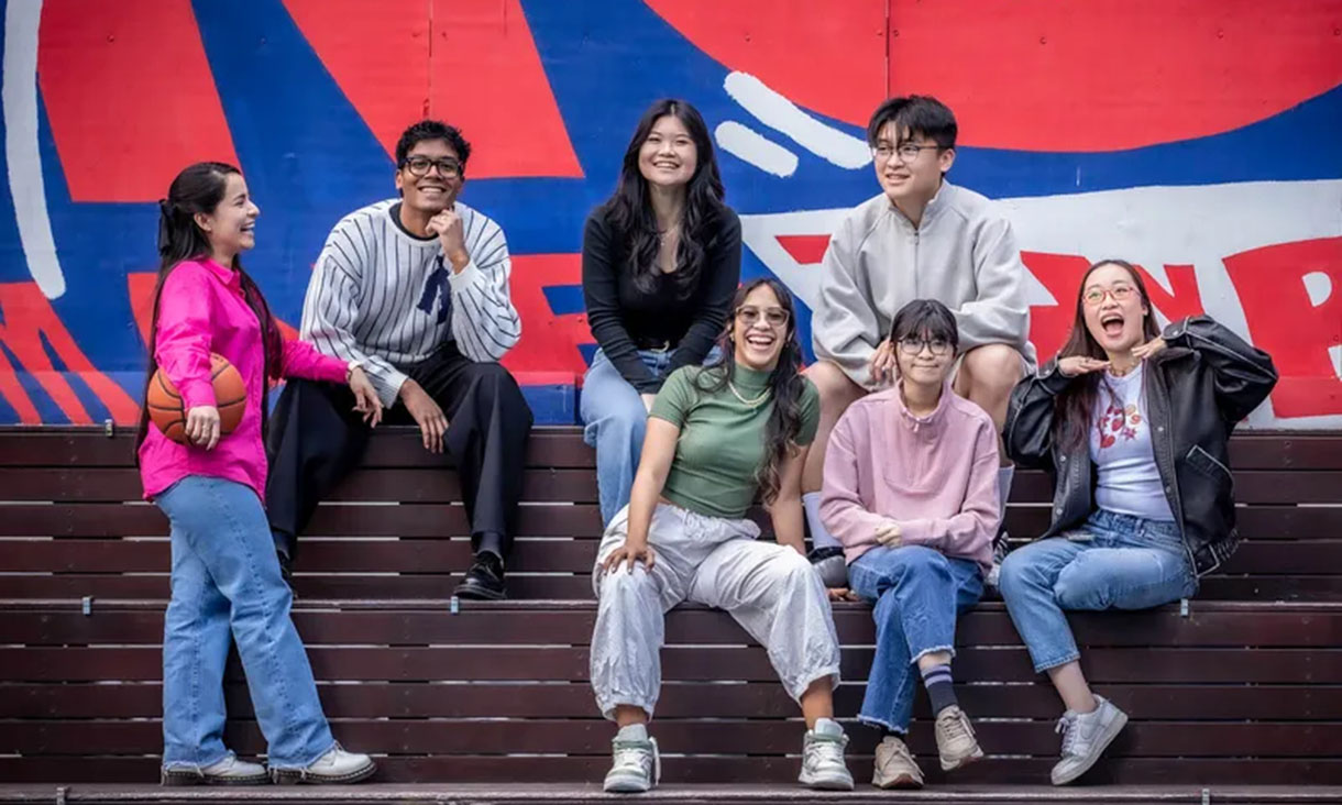 Smiling students on campus stairs