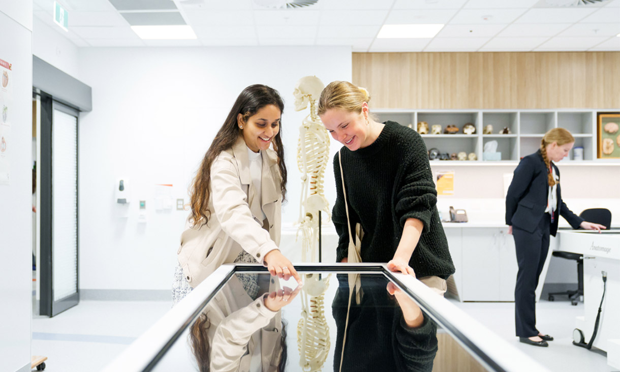 Two students and a teacher in a biomedical science lab at the RMIT Bundoora campus