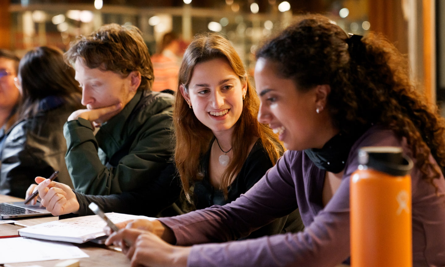 Students studying on campus side by side on a large table