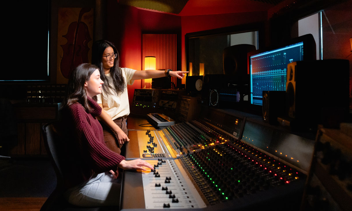 Two students working in an audio engineering space at RMIT
