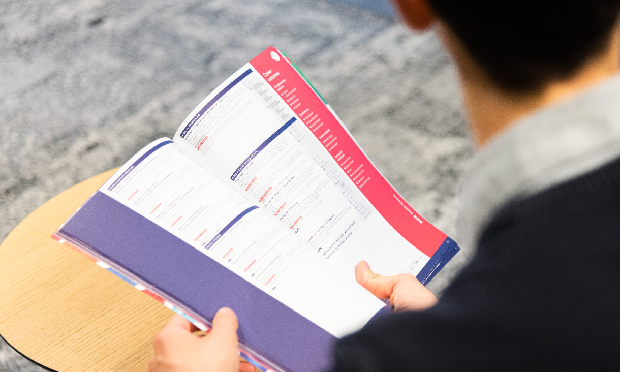 A student looking at an RMIT course guide