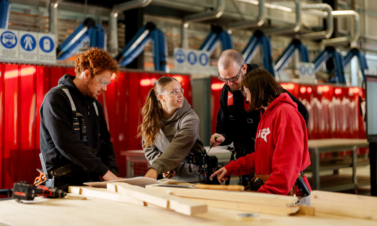 Students and teachers at a workbench in the Trades Innovation Centre