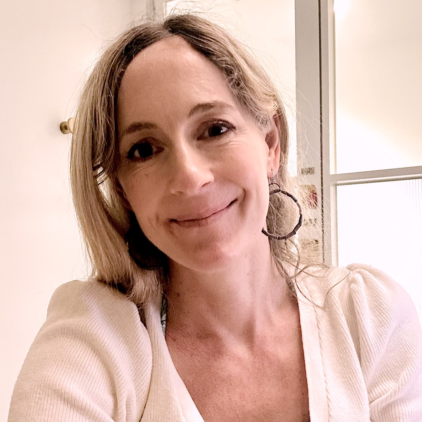 photo of nicola henry in pale pink shirt smiling