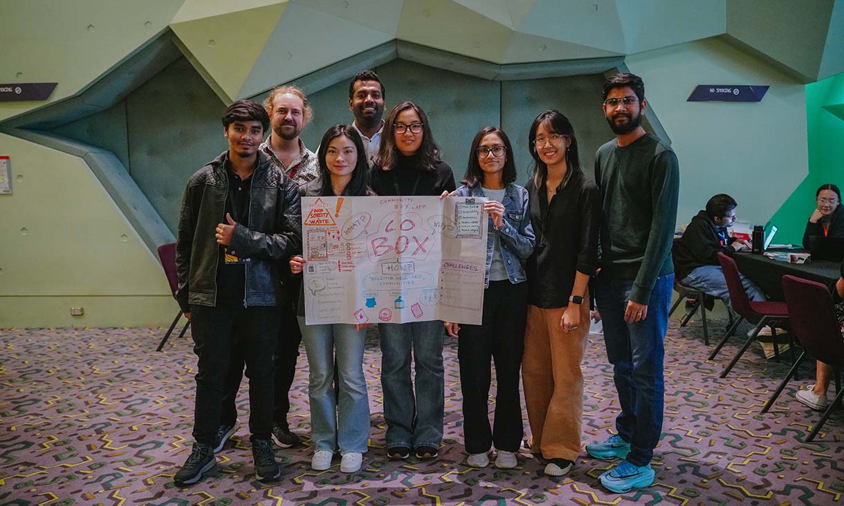 Photo of students holding up a piece of paper