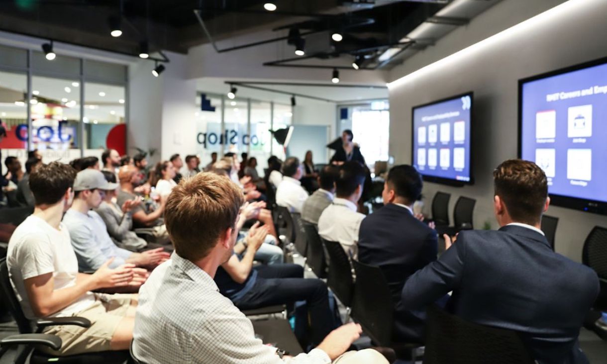 People sitting in rows watching a presentation