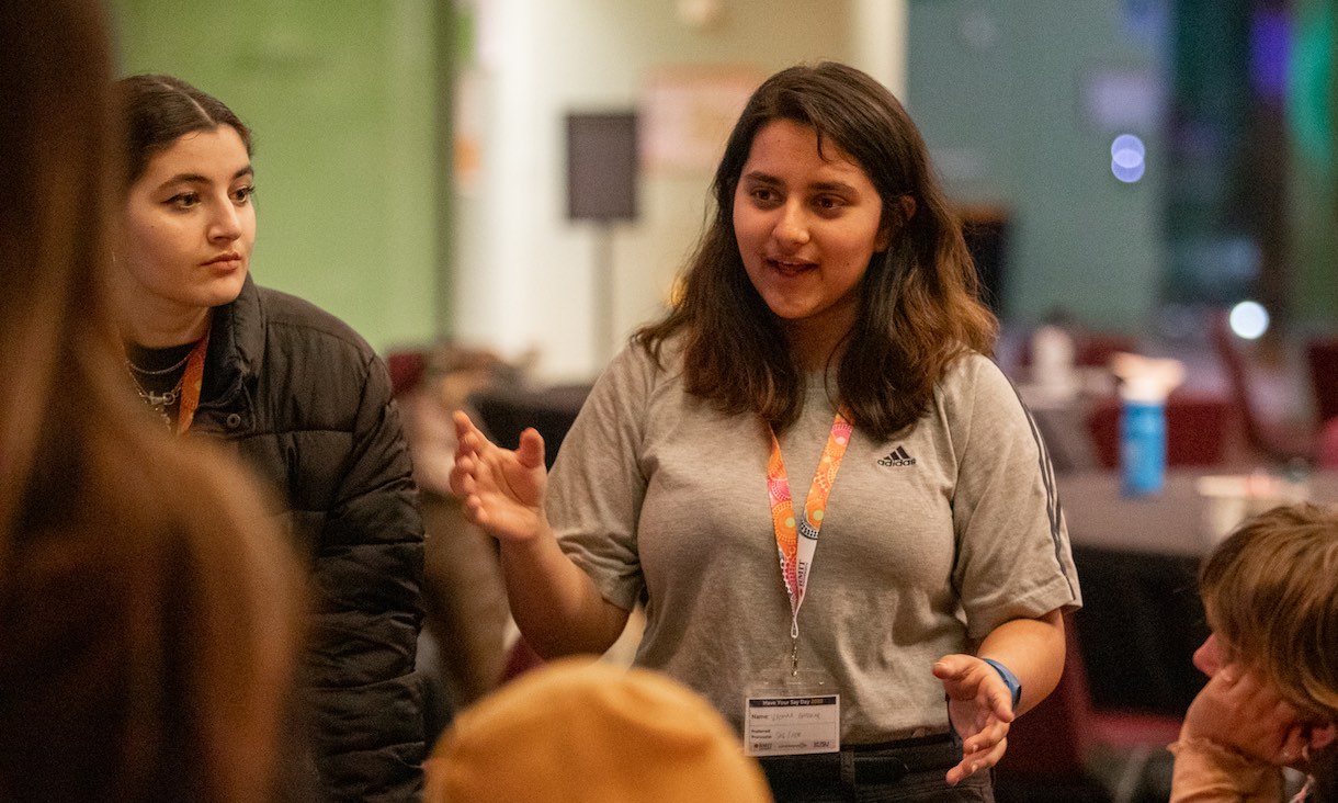 Student talking to a group.