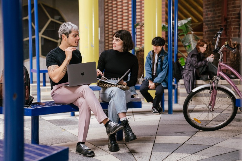 A group of people looking at various devices