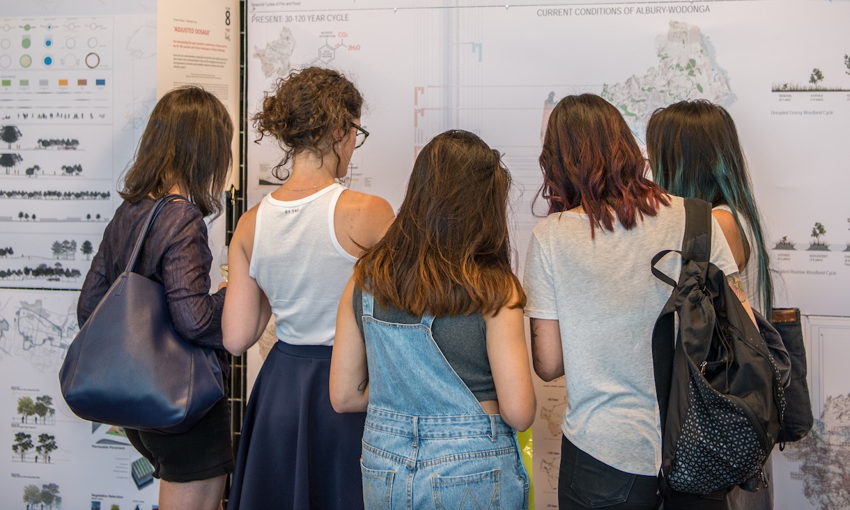 Students look at an exhibition.
