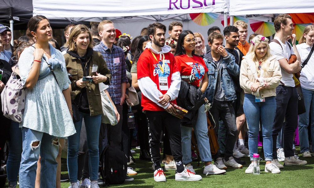 Students gather to watch an event on campus.