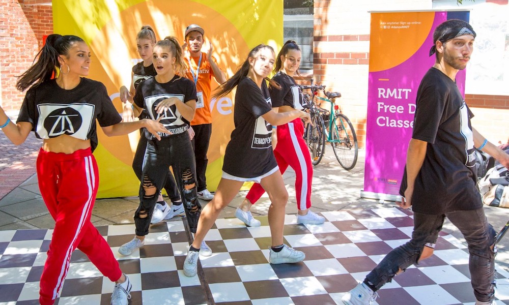 Students perform a dance on campus.