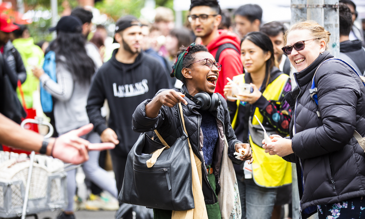 Students laugh together at an event.
