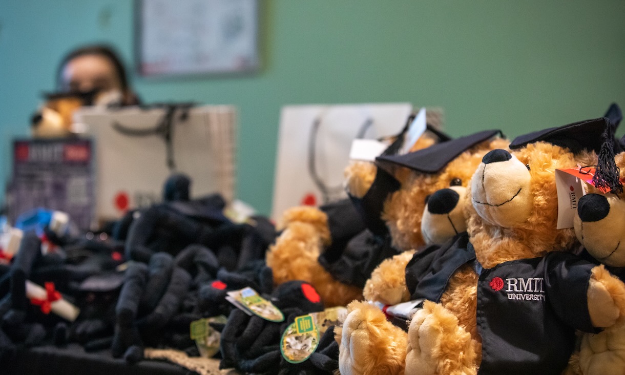 A table with graduation teddy bears and merchandise.