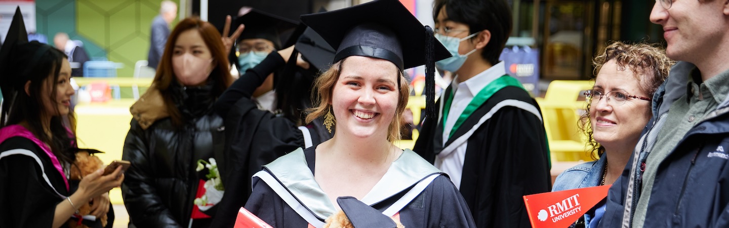 Graduate smiling at the Graduation Parade.