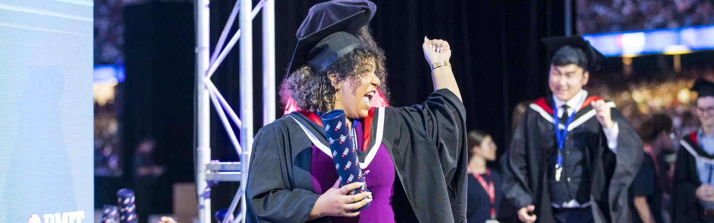 Graduate cheers as they get their testamur.