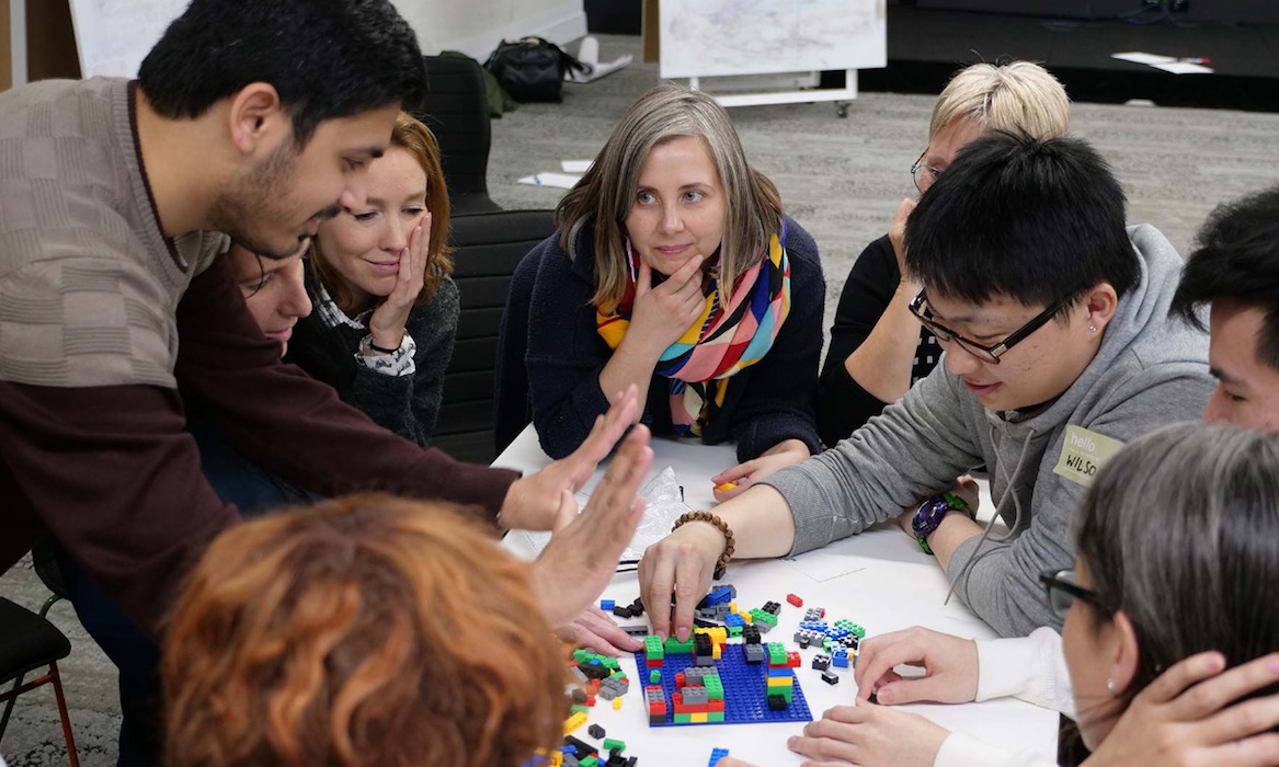 Students complete a lego exercise in class.