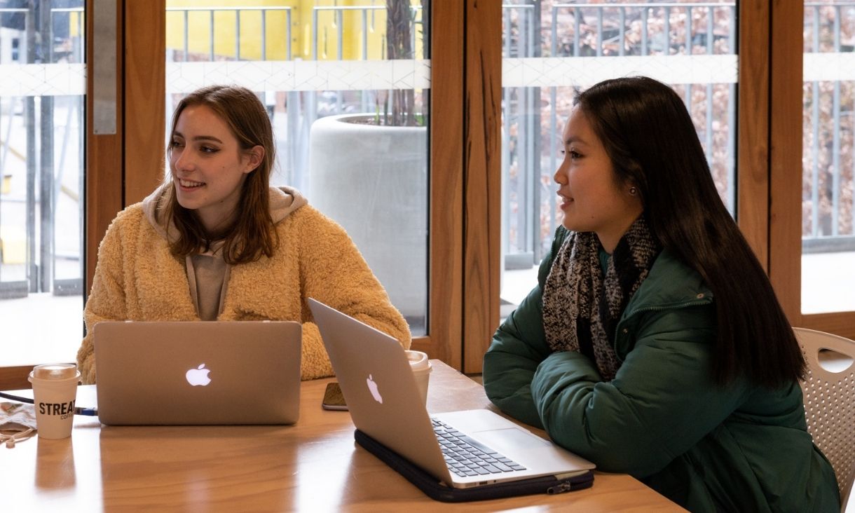 Two students study together on campus.
