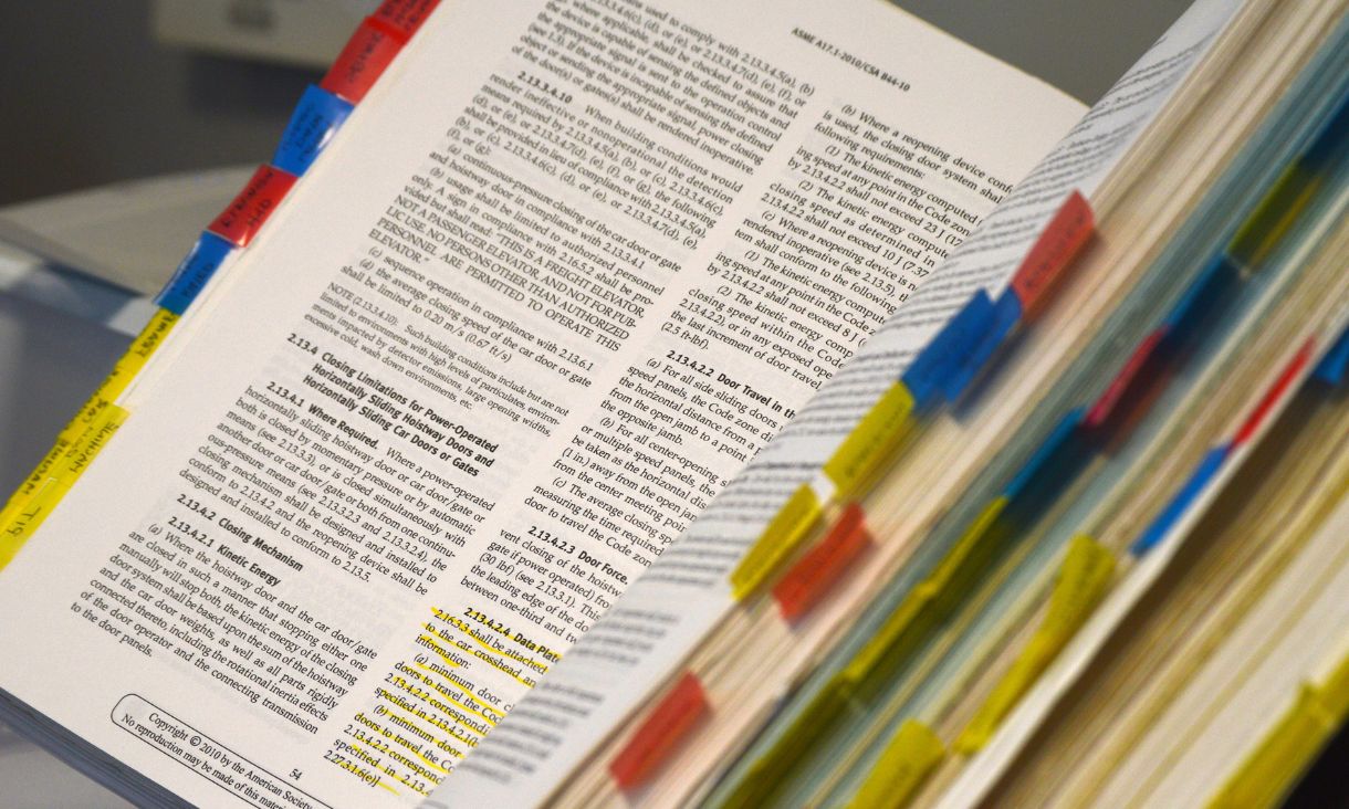 An open book with tabs marking pages.