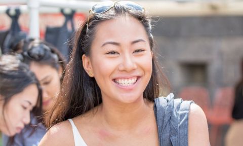 A student smiles at the camera.