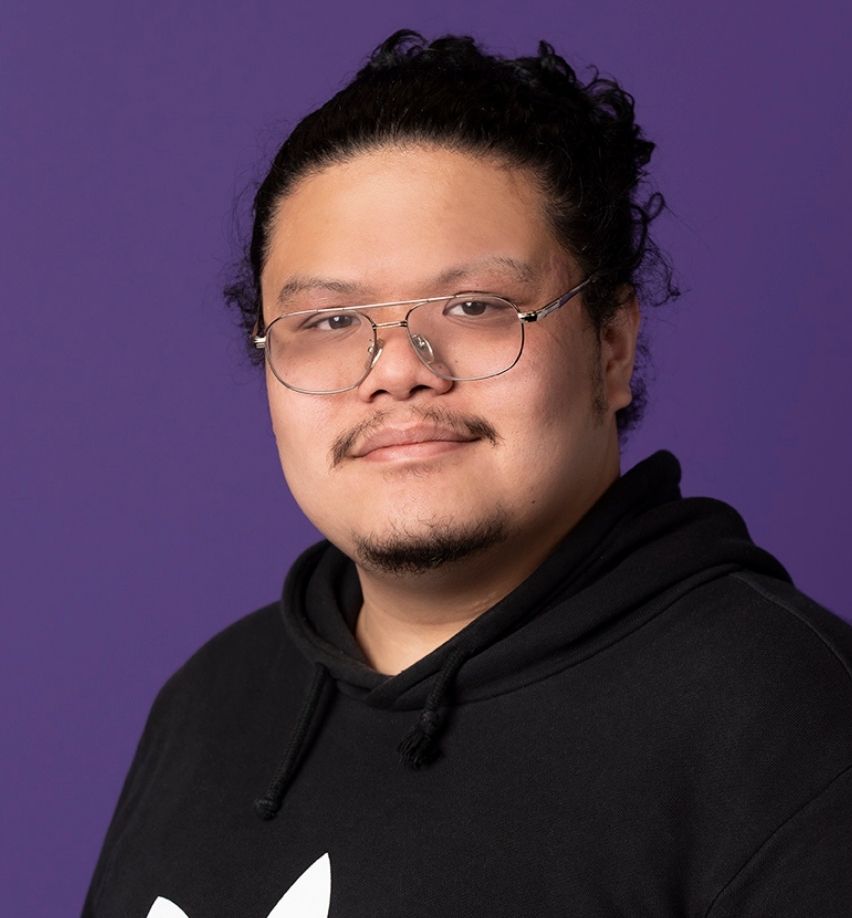 Mark looking directly at camera with purple background 