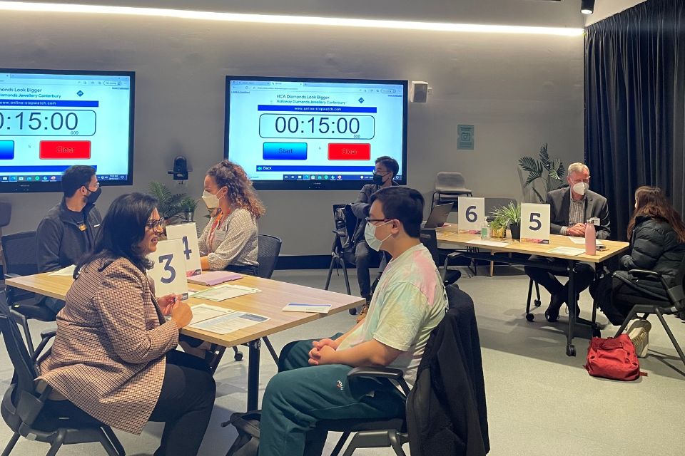 International students having their resumes reviewed by industry mentors at the workshop 