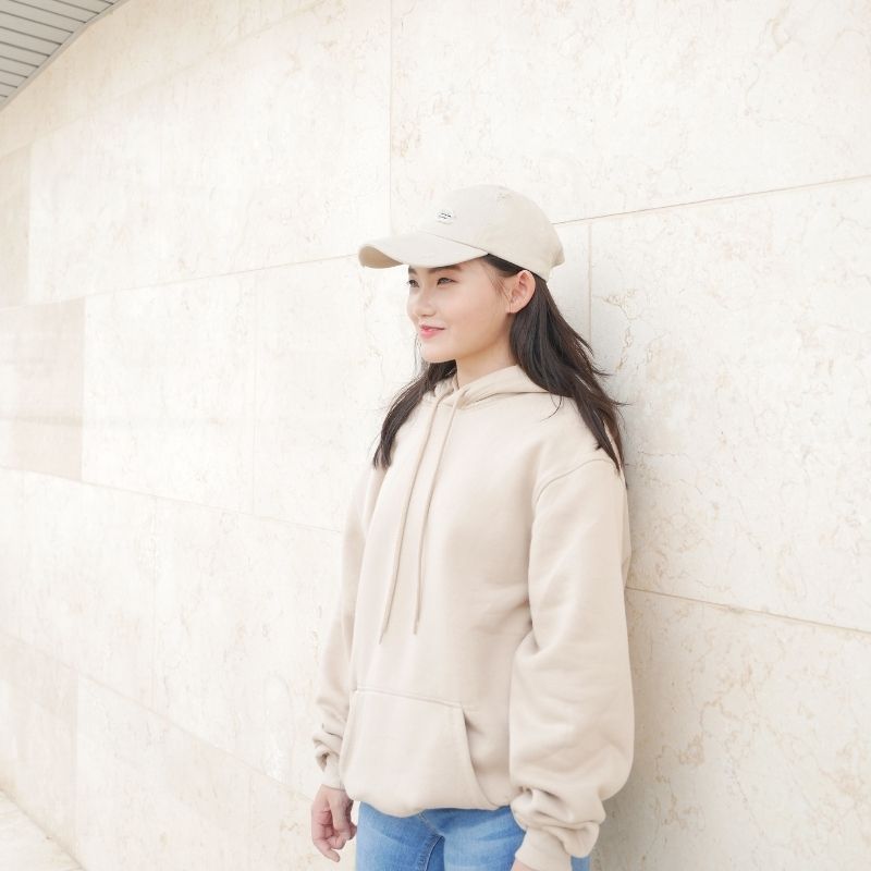 Image of Vanessa wearing a hoodie and cap.