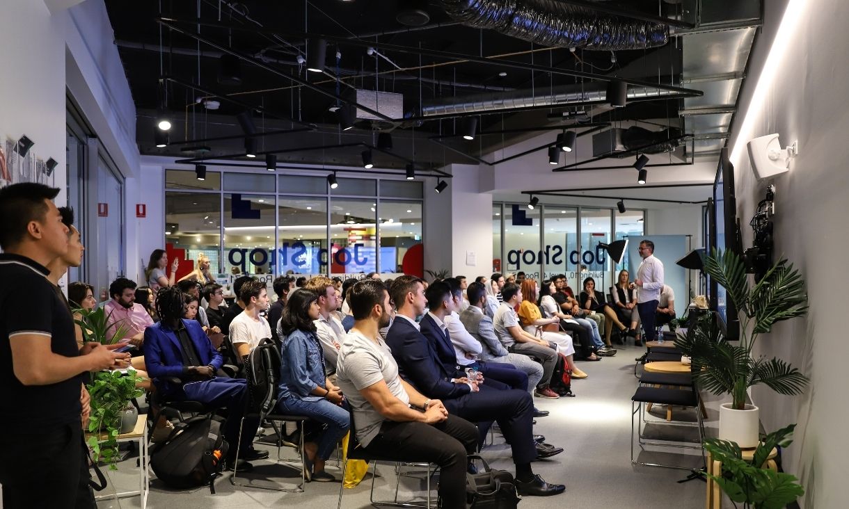 Students in the Job Shop listening to a presentation.
