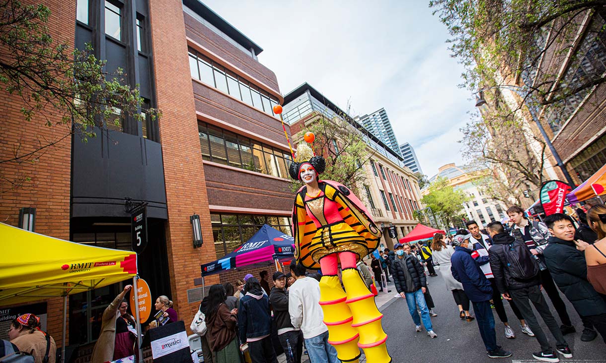 Entertainer on stilts among a crowd