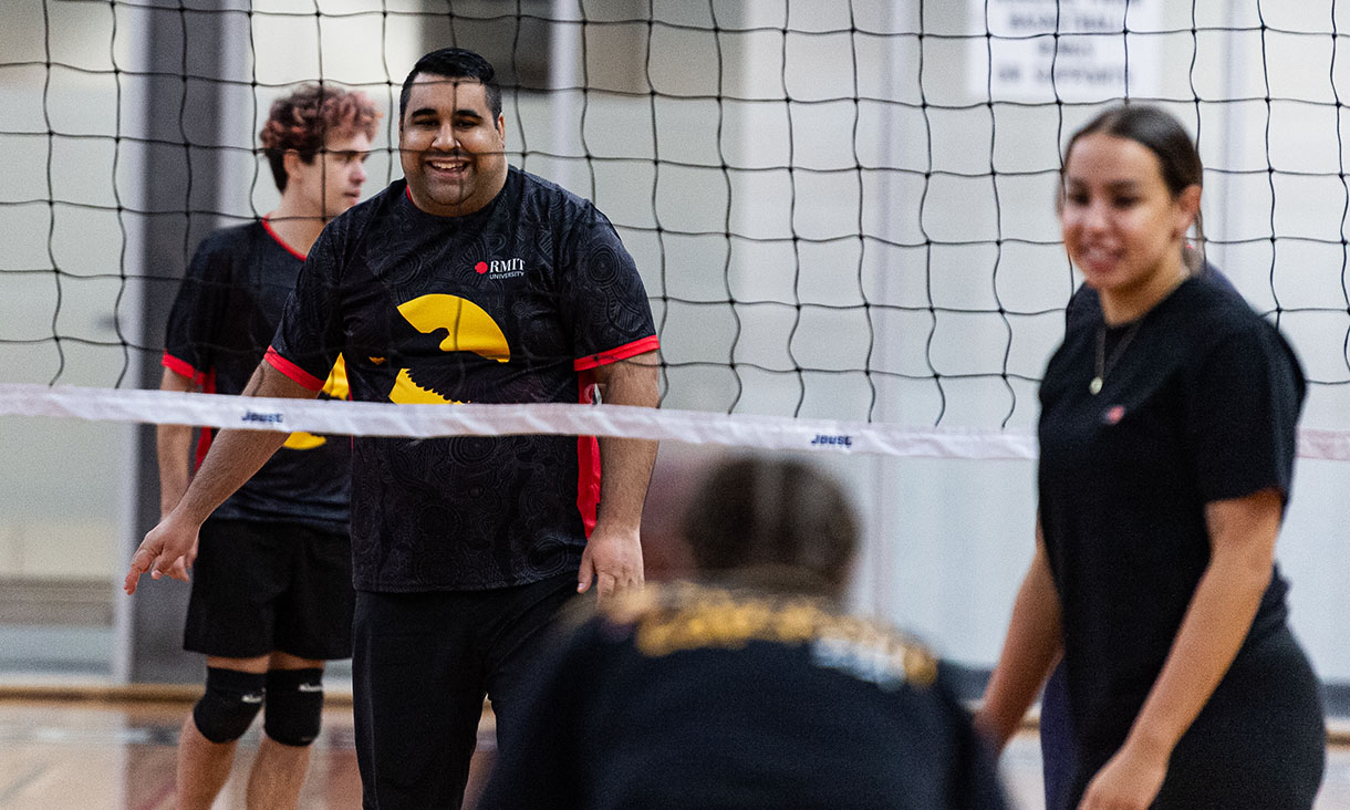 Students prepare for a volleyball serve