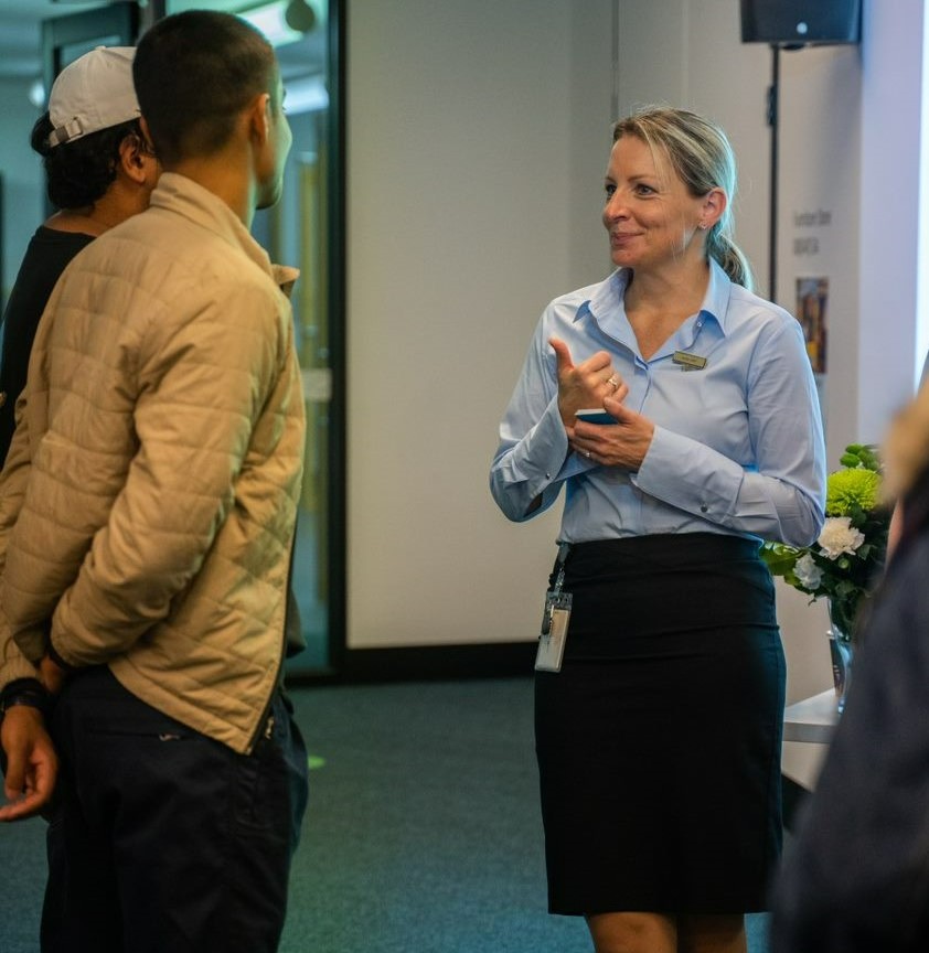 employer Anne List giving thumbs up to two students