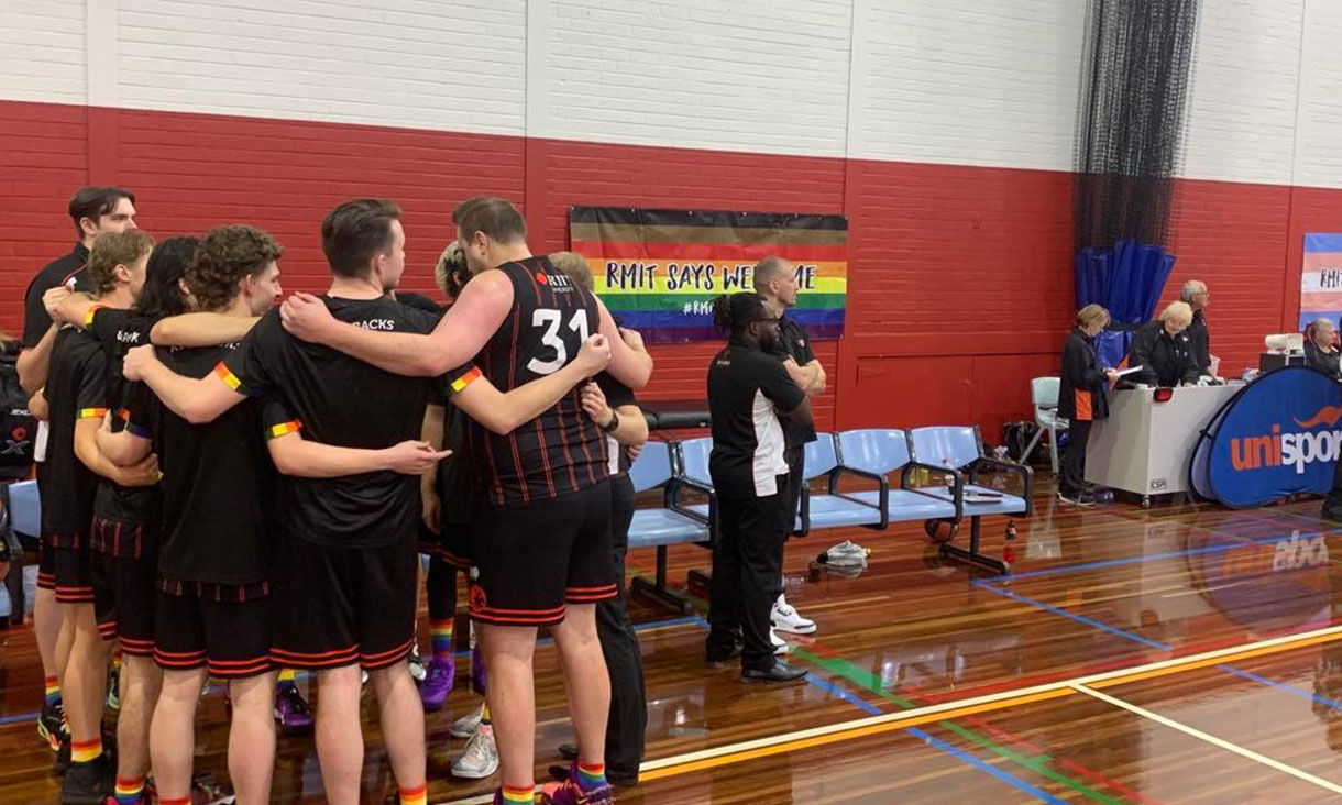 RMIT men's basketball team in a huddle