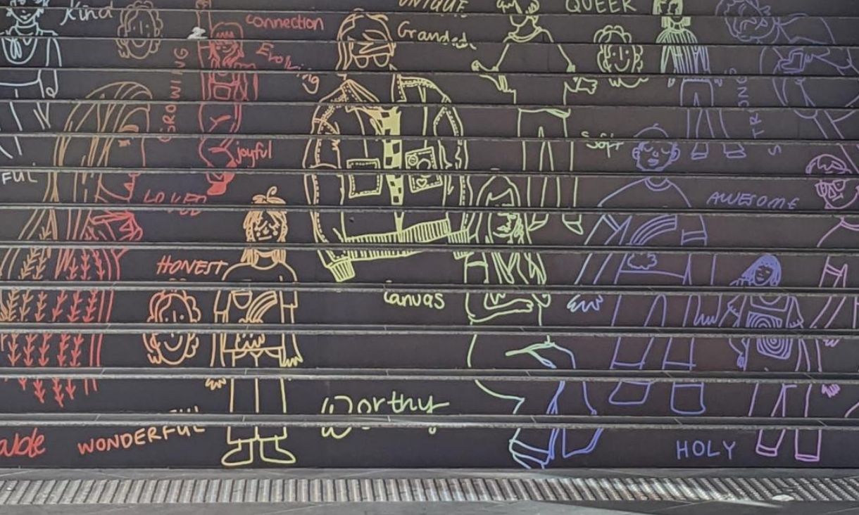 Grey steps leading up to Building 8 on RMIT City Campus showing colourful stencil artwork.